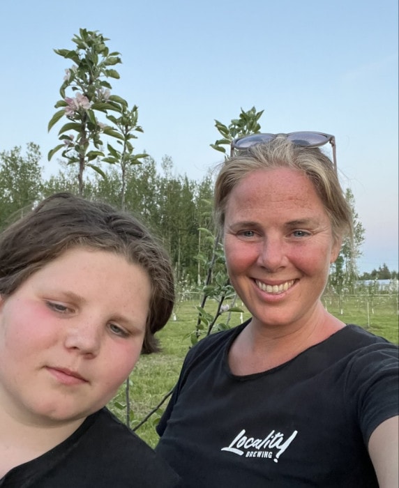 Melanie with her son Lachlan picking apples on the farm at Locality Brewing in Langley on the Langley Ale Trail